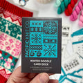 Hand holding the teal and black Winter Doodle Card Deck by Pacific Knit Co tuckbox