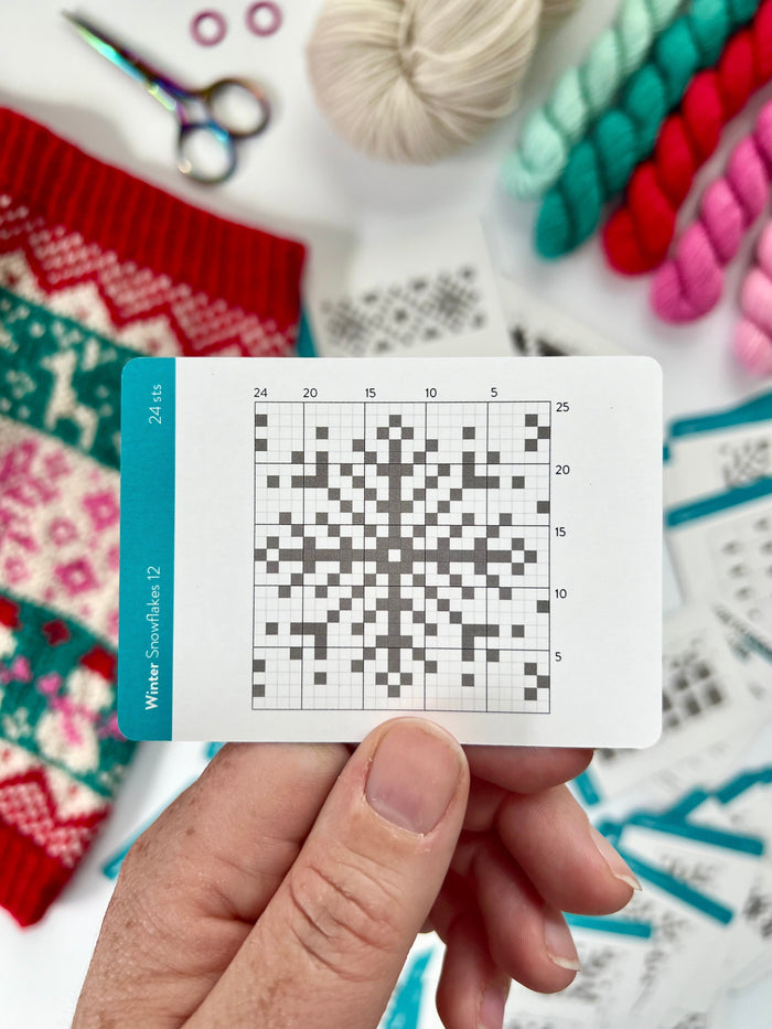 Hand holding a Winter Doodle snowflake colorwork chart card