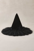 Black witch hat with a tulle base on a beige background
