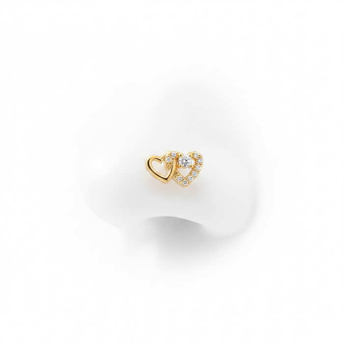 A luxury 18k gold-dipped nose stud featuring two interlocking hearts—one in polished gold and the other pavé-set with brilliant crystals—crafted from tarnish-resistant titanium steel for a minimalist editorial look.