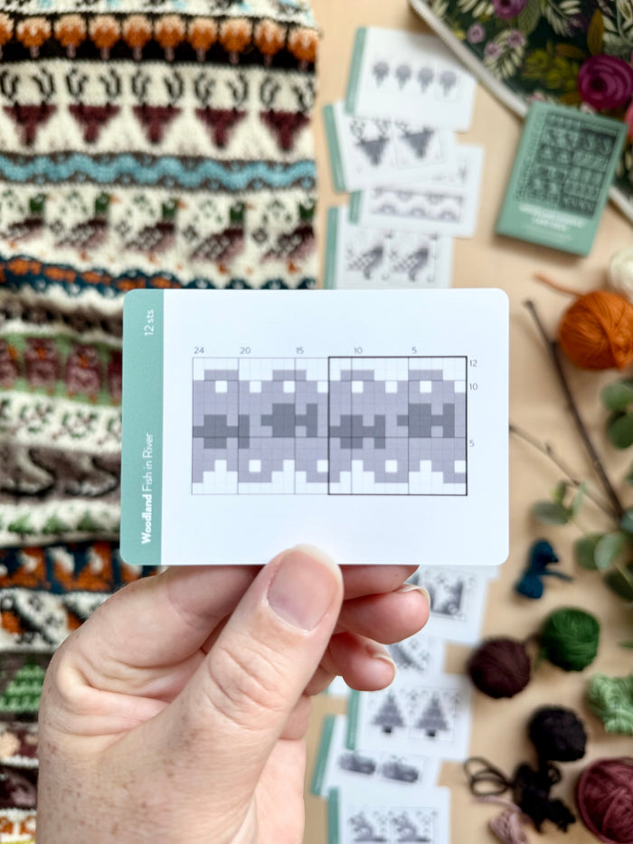 Hand holding a Woodland Doodle pine boughs colorwork chart card