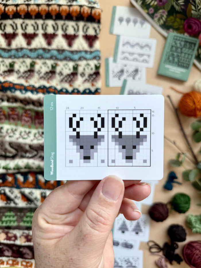 Hand holding a Woodland Doodle stag colorwork chart card