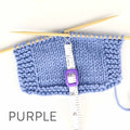 Work Until measuring tape in purple color hooked onto a blue knit swatch on bamboo needles showing the retractable white tape extended to measure rows