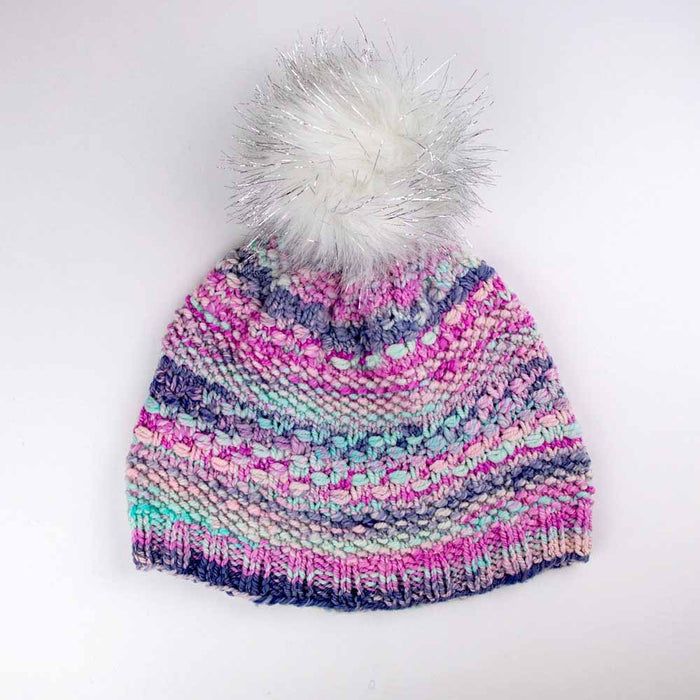 Multicolor pink purple and mint knitted Wrapped Together beanie with white sparkle faux fur pom pom on white background