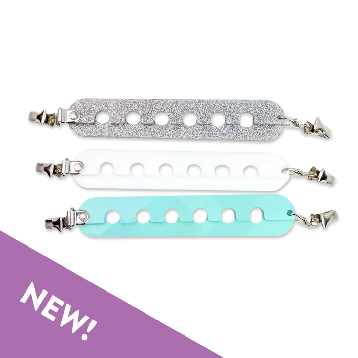 Two Yarn Gator colorwork yarn dividers — one silver glitter and one mint — with lobster claw clips and slotted holes for separating yarn strands, with NEW badge