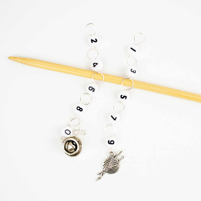 Yarn & Tea Time odd/even row counter chains on a bamboo knitting needle with silver yarn ball charm for even numbers and silver tea cup charm for odd numbers