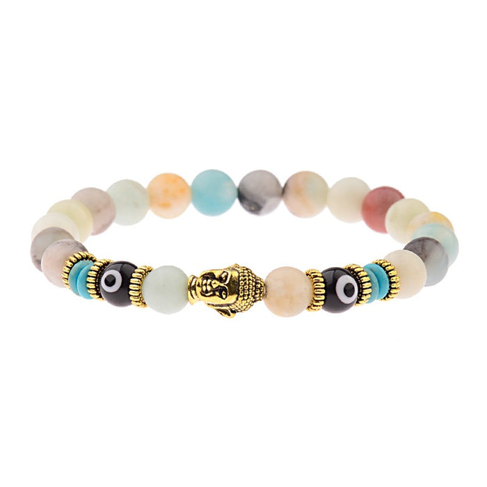 Spiritual beaded bracelet featuring multi-colored natural stone beads, a golden Buddha head charm, and black evil eye beads with gold-tone accents.